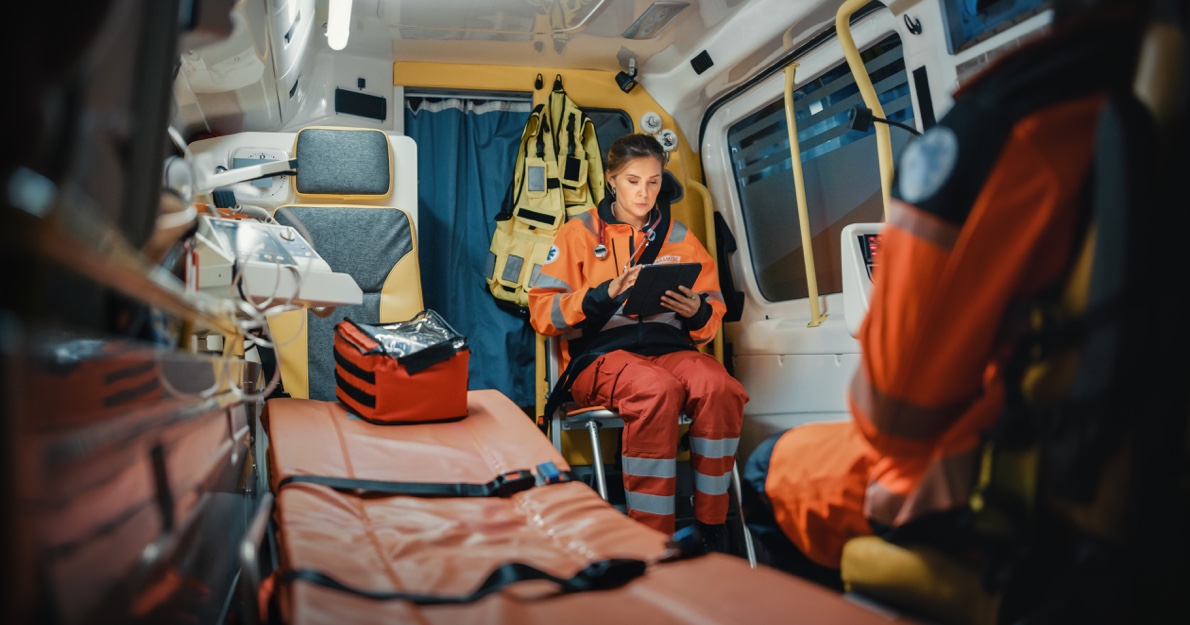 EMS Techs in an ambulance studying a chart - HealthStream
